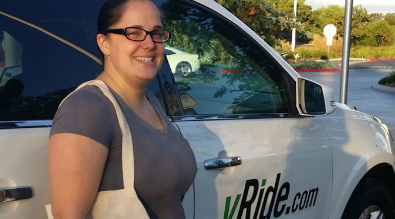 Woman standing in front of uRIde car